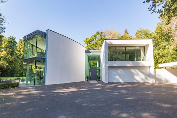 driveway view of modern house with large windows