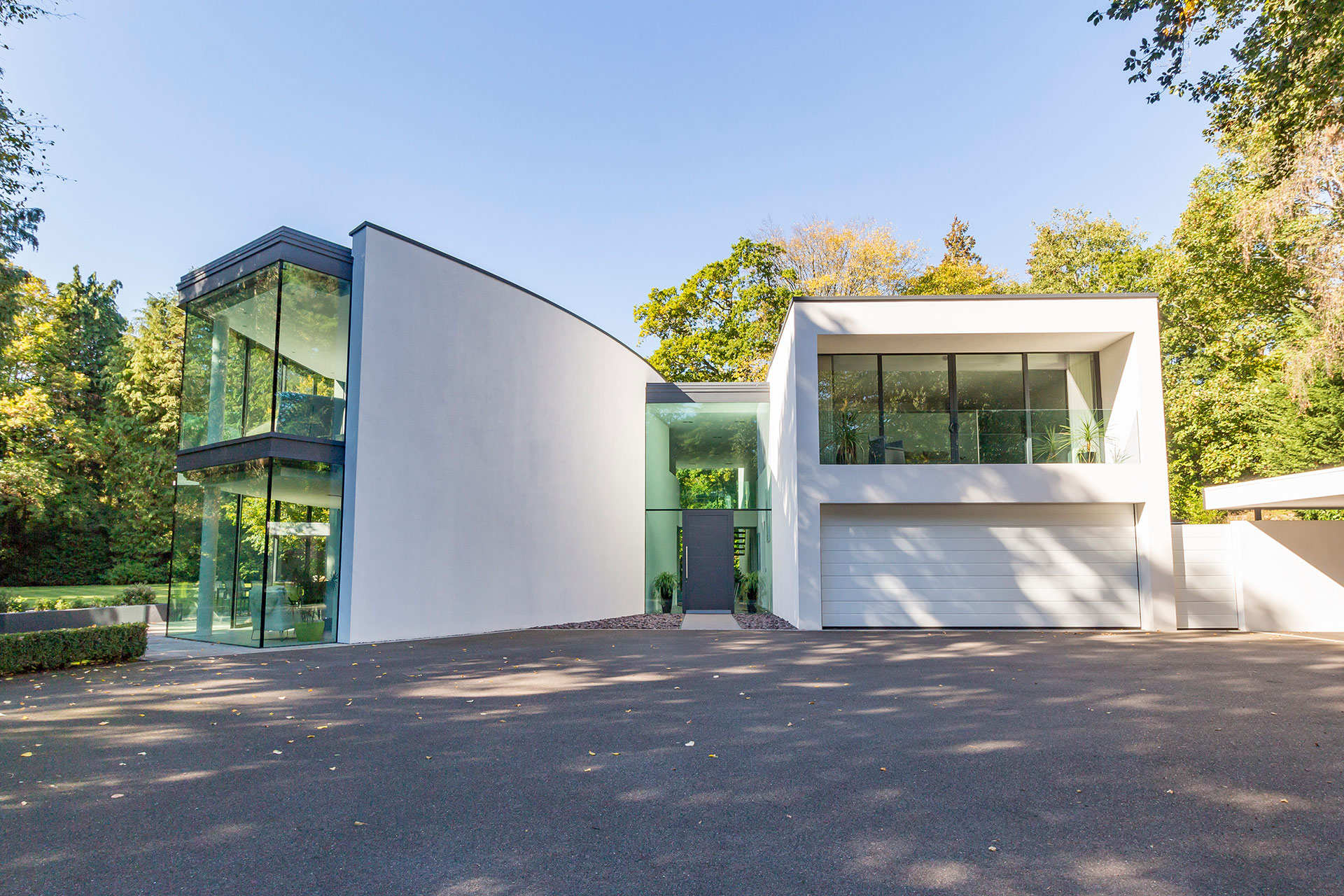 driveway view of modern house with large windows