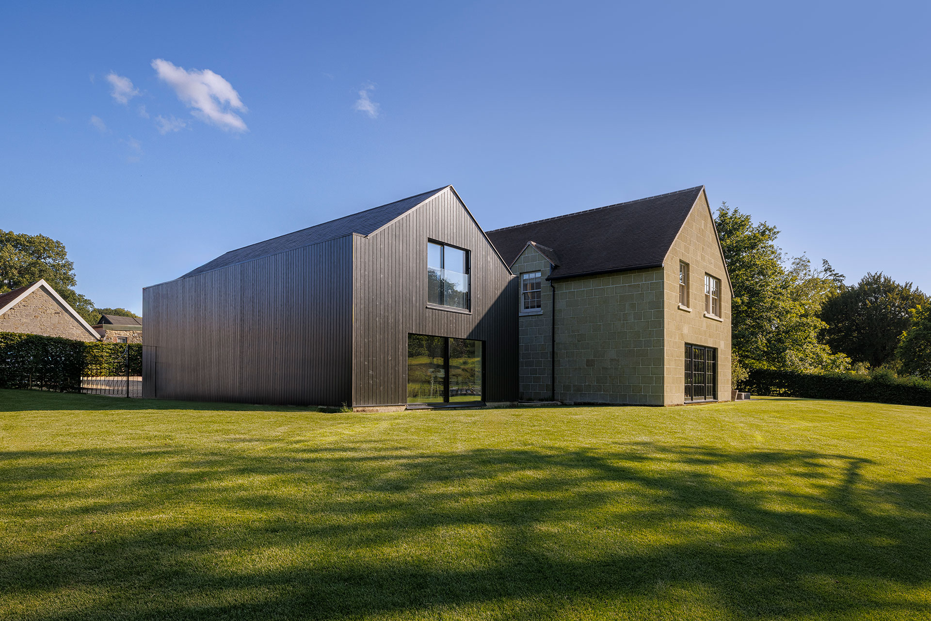 rear view of house with stone and timber cladding in day
