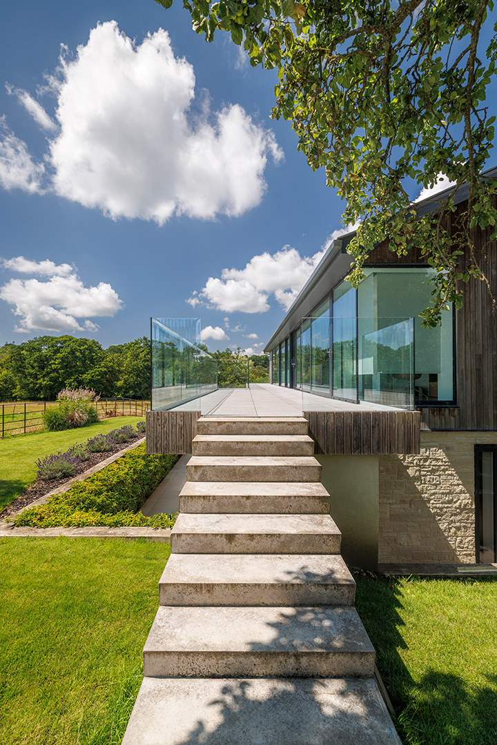 external concrete staircase leading to first floor of house with large balcony